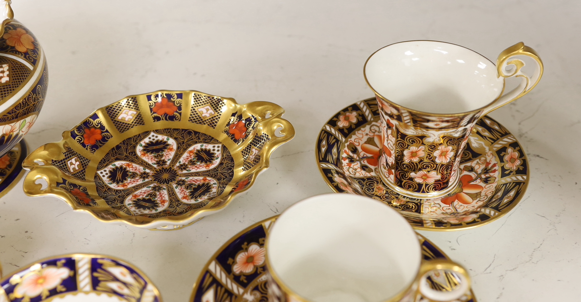A Royal Crown Derby spherical vase with pie crust rim painted with pattern 1128, a two handled dish in the same pattern, five cups and three saucers in pattern 2451